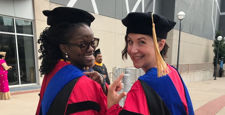 two women in cap and gown