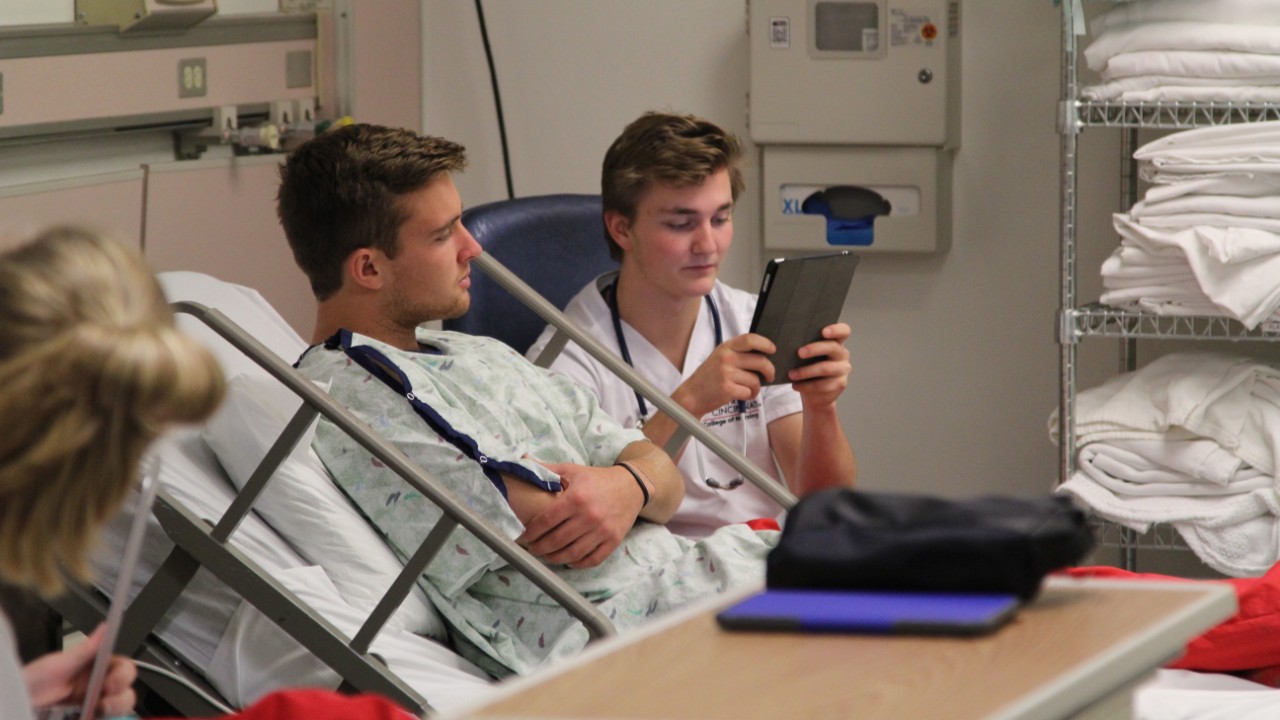 Students using an iPad in the simulation lab